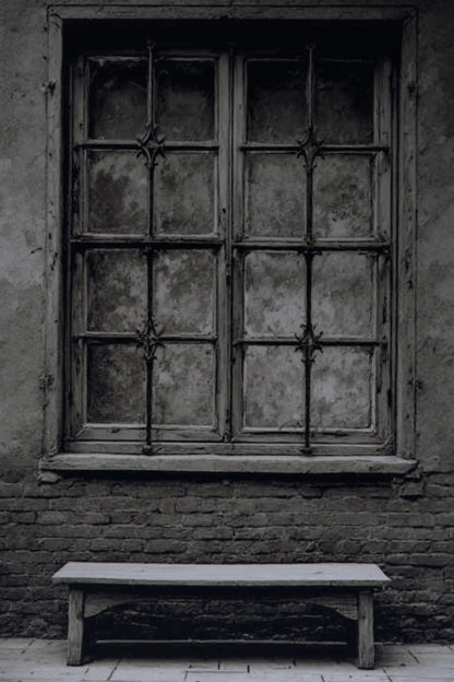 A dark, moody photograph of an old, weathered wooden window with multiple panes and a rustic brick wall behind it, with a simple wooden bench in the foreground.