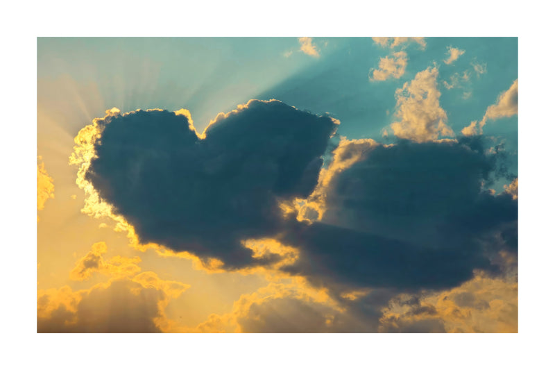 A square art print depicting a dramatic sunset sky with a heart-shaped cloud silhouette, golden sun rays bursting through, and clouds illuminated in warm yellow and blue tones.