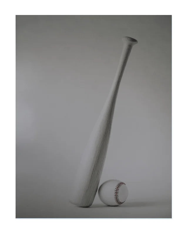 A minimalist studio photograph of a light gray wooden baseball bat leaning against a baseball, set against a matching gray background.