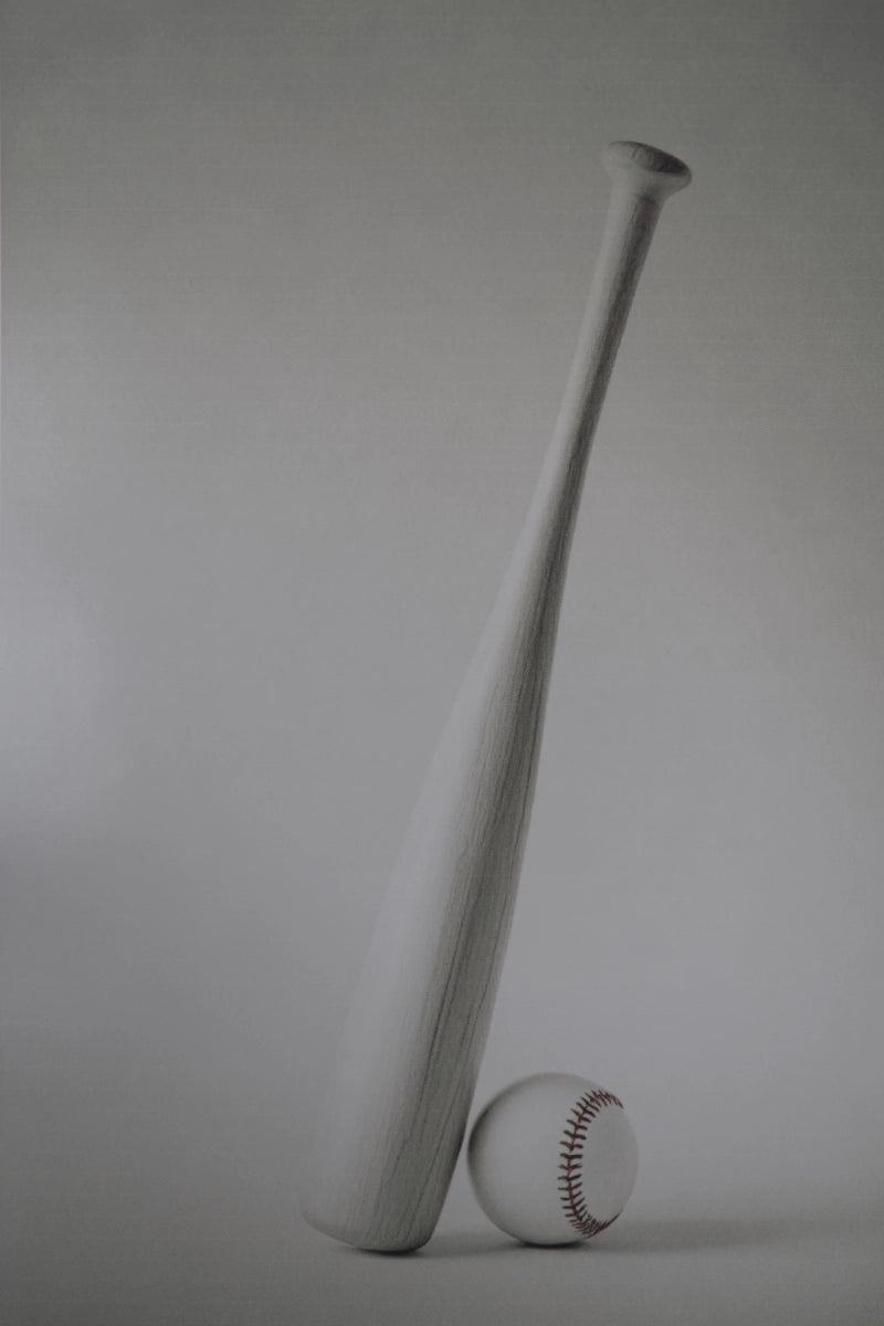 A matte white baseball bat standing upright next to a white baseball with red stitching, set against a neutral gray studio background.