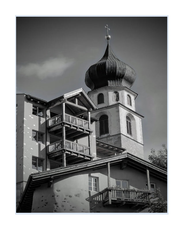 Black and white architectural photograph of a church tower with a onion dome and balconies, presented as a square art print with a white border.