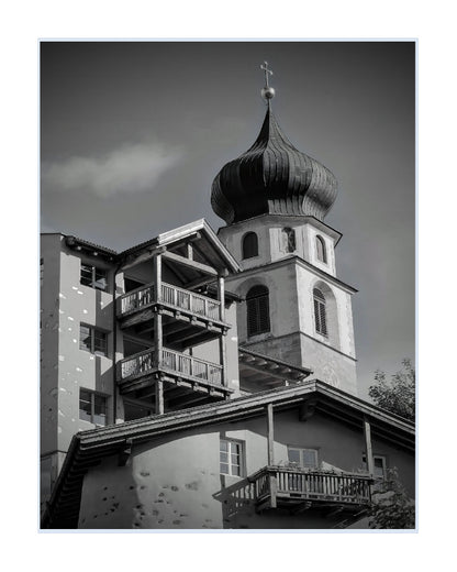 Black and white architectural photograph of a church tower with a onion dome and balconies, presented as a square art print with a white border.