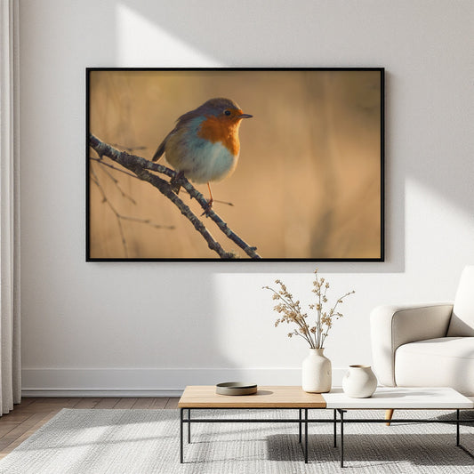 A framed wall art print showing a small bird perched on a branch, displayed in a modern living room setting above a coffee table and sofa.