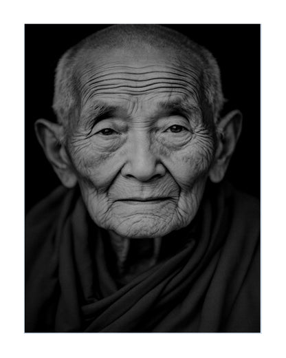Black and white portrait print of an elderly buddhist woman with deep facial wrinkles, wearing a dark draped garment against a black background.