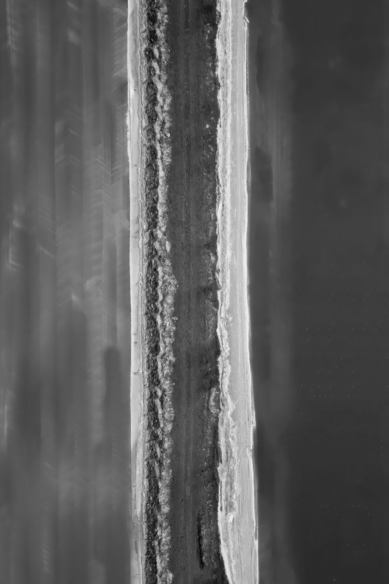 A square black and white abstract painting featuring a vertical textured band of gray, white, and black tones flanked by blurred gray brushstrokes.