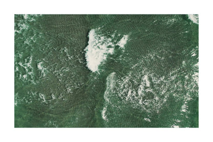 A square art print or photograph showing an aerial view of green water with white foam and ripple patterns, presented on a white background with a thin gray border.
