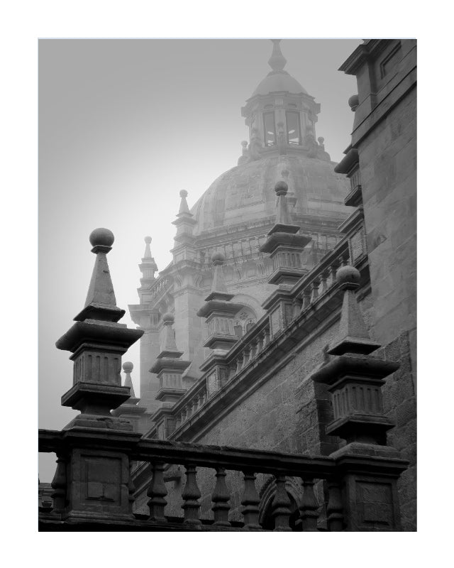 Black and white architectural photograph of a grand domed cathedral or historic building, framed by stone balustrades in the foreground.