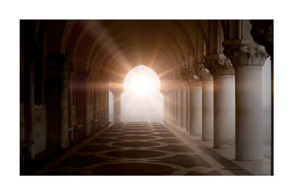 A scenic photograph of a grand stone colonnade with arches and columns, featuring dramatic sunlight streaming through the center arch and illuminating the misty background.