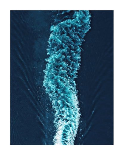 Aerial view of a boat's turquoise wake cutting through deep blue water, presented as a square art print with white borders.