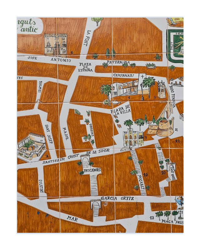 A square illustrated map tile featuring a stylized street layout with labeled roads, buildings, palm trees, and small decorative elements in brown, white, green, and black.
