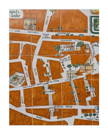 A square illustrated map tile featuring a stylized street layout with labeled roads, buildings, palm trees, and small decorative elements in brown, white, green, and black.