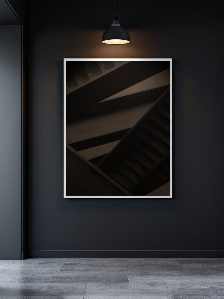 A framed abstract photograph of a dark staircase with warm lighting, displayed on a dark charcoal wall in a modern interior setting.