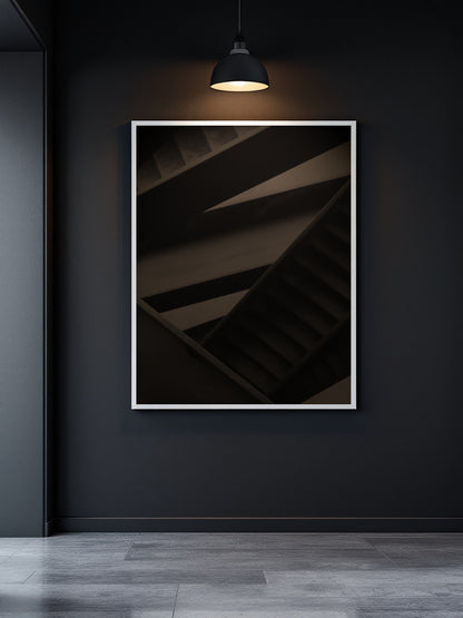 A framed abstract photograph of a dark staircase with warm lighting, displayed on a dark charcoal wall in a modern interior setting.