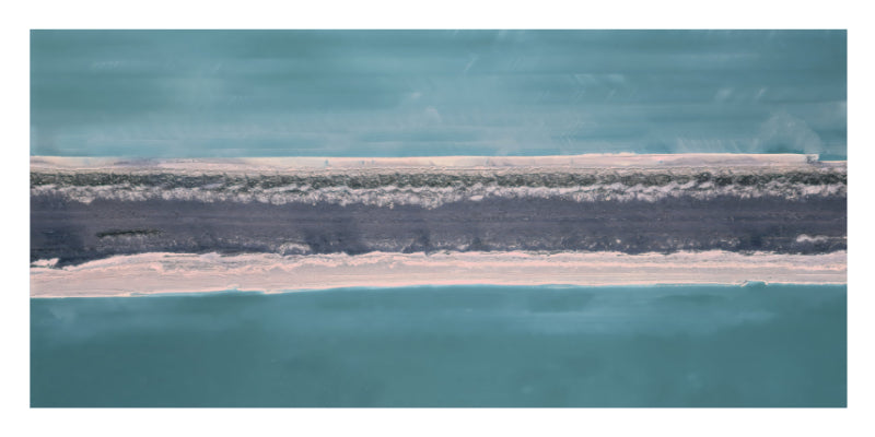 An abstract landscape-style artwork showing a narrow horizontal strip of pale pink sand or dune between bands of dark gray and teal-blue water or sky.