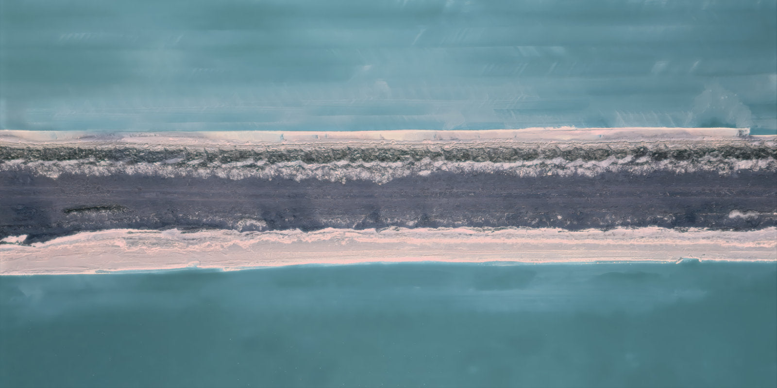 Aerial abstract representation of a narrow strip of pale sand and dark vegetation between two large areas of turquoise water.
