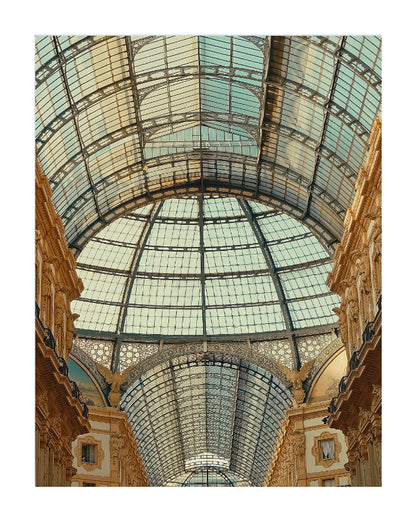 A vertical art print depicting the grand arched glass dome ceiling of the Galleria Vittorio Emanuele in Milan, framed by ornate beige stone columns on either side.