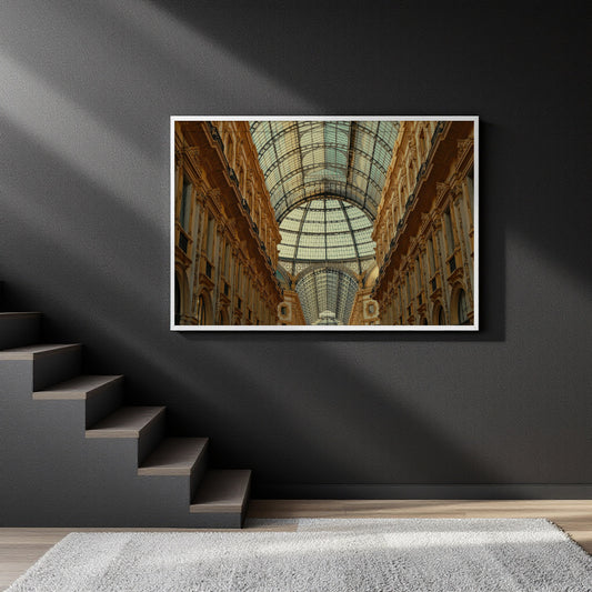 A framed art print depicting a grand glass-domed gallery with warm-toned columns, displayed on a dark gray wall above a staircase.