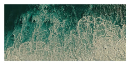 An aerial-style photograph of ocean water with swirling teal, green, and white foam patterns filling the frame.