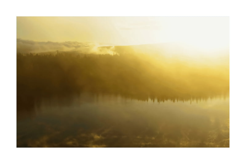 A misty golden landscape scene with a calm lake reflecting a dark treeline and mountains under bright low sunlight.