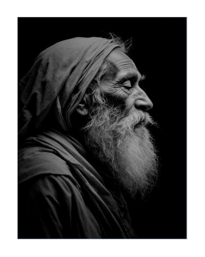 Black and white portrait print of an elderly man with a long beard and head covering, shown in profile against a dark background.